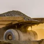 Strengthening GHG Management in Gold Mining Operations 3 Mining haul truck loaded with rock at sunset